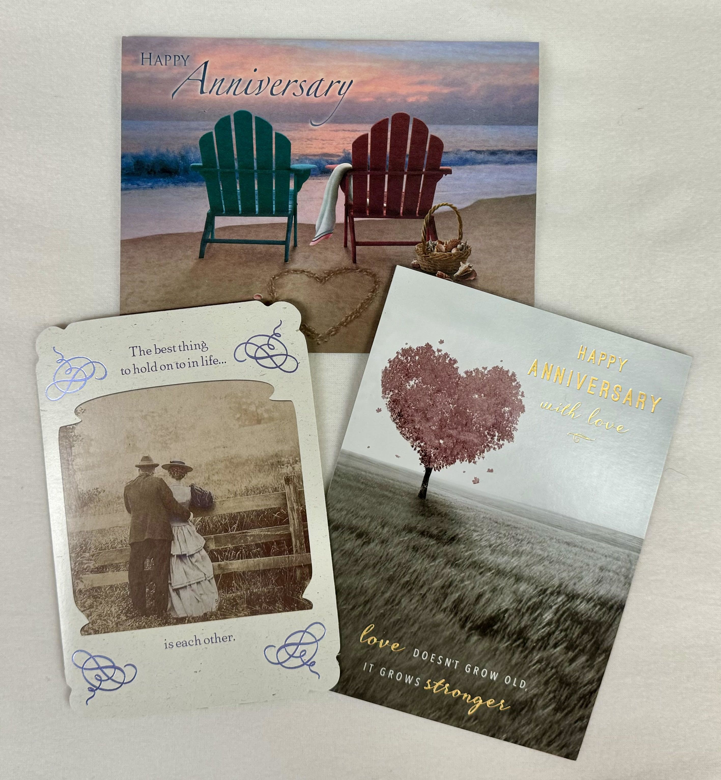Three anniversary greeting cards with beach and heart designs