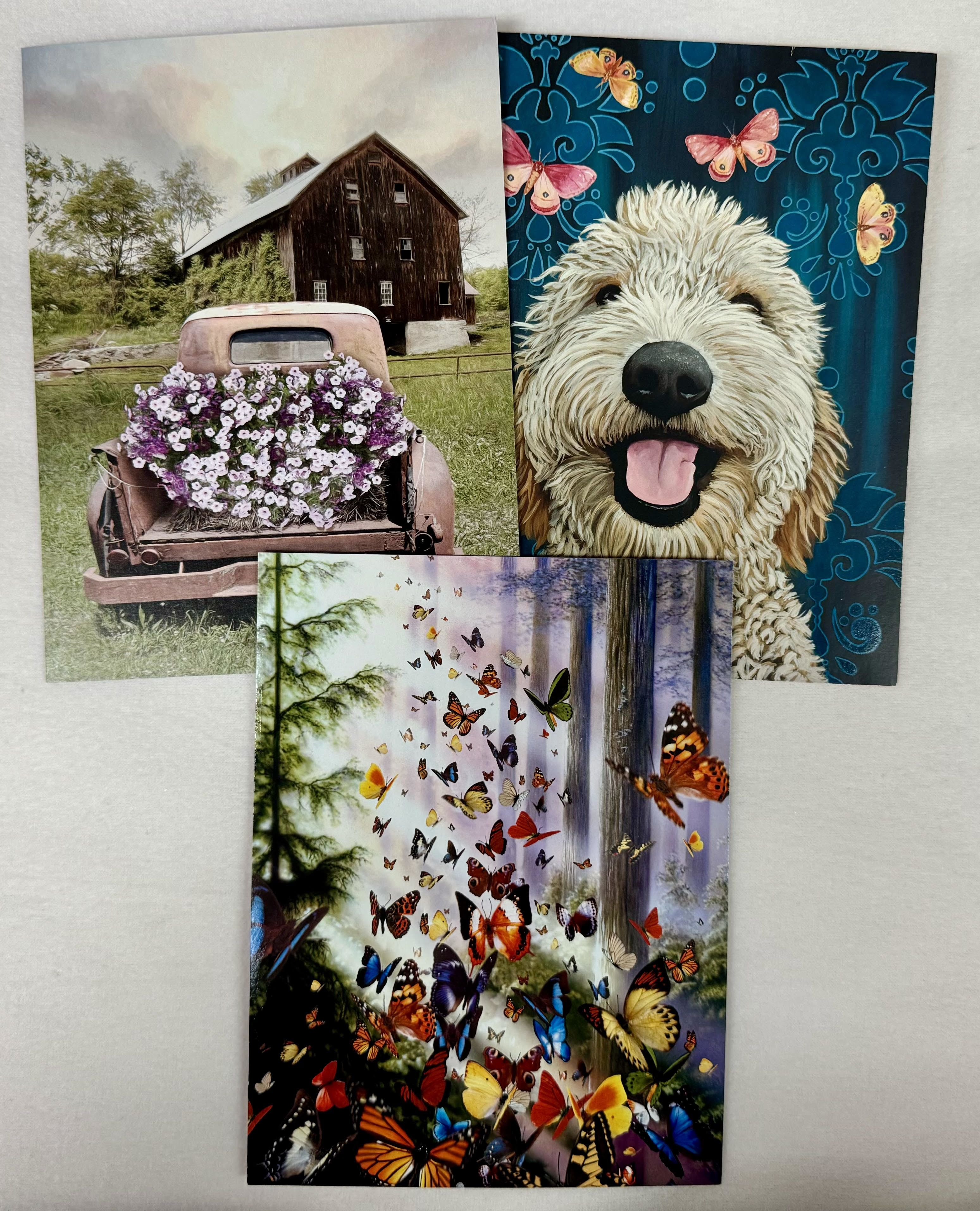 Three decorative cards with a dog, butterflies, and a flower-covered truck
