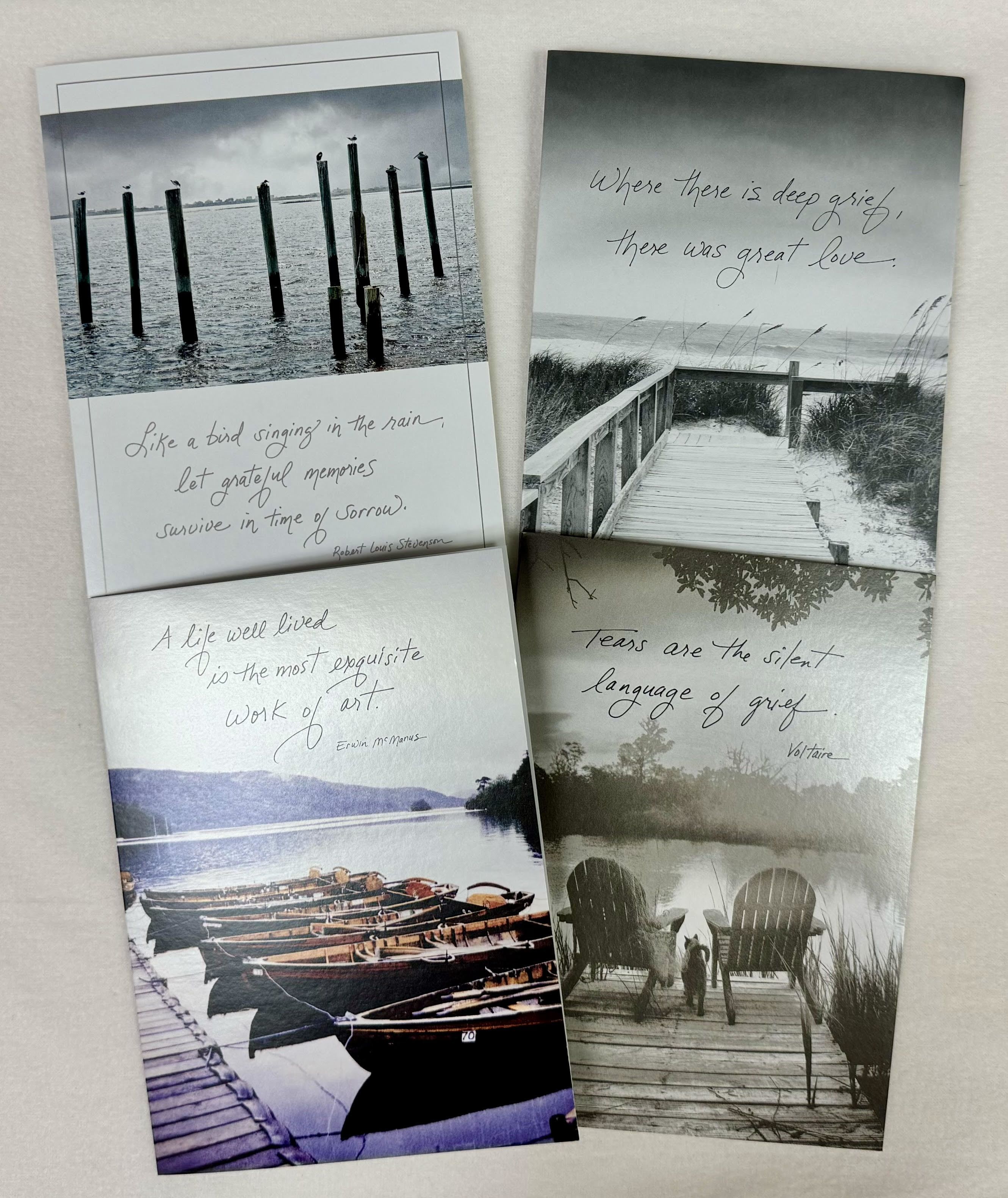 Four sympathy cards with grayscale lake and dock scenes and grief quotes