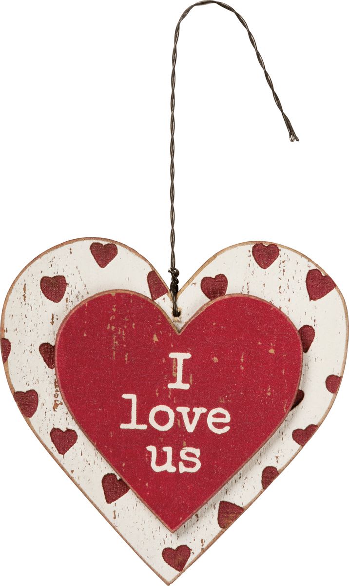 Heart-shaped hanging sign with red hearts and the words I love us