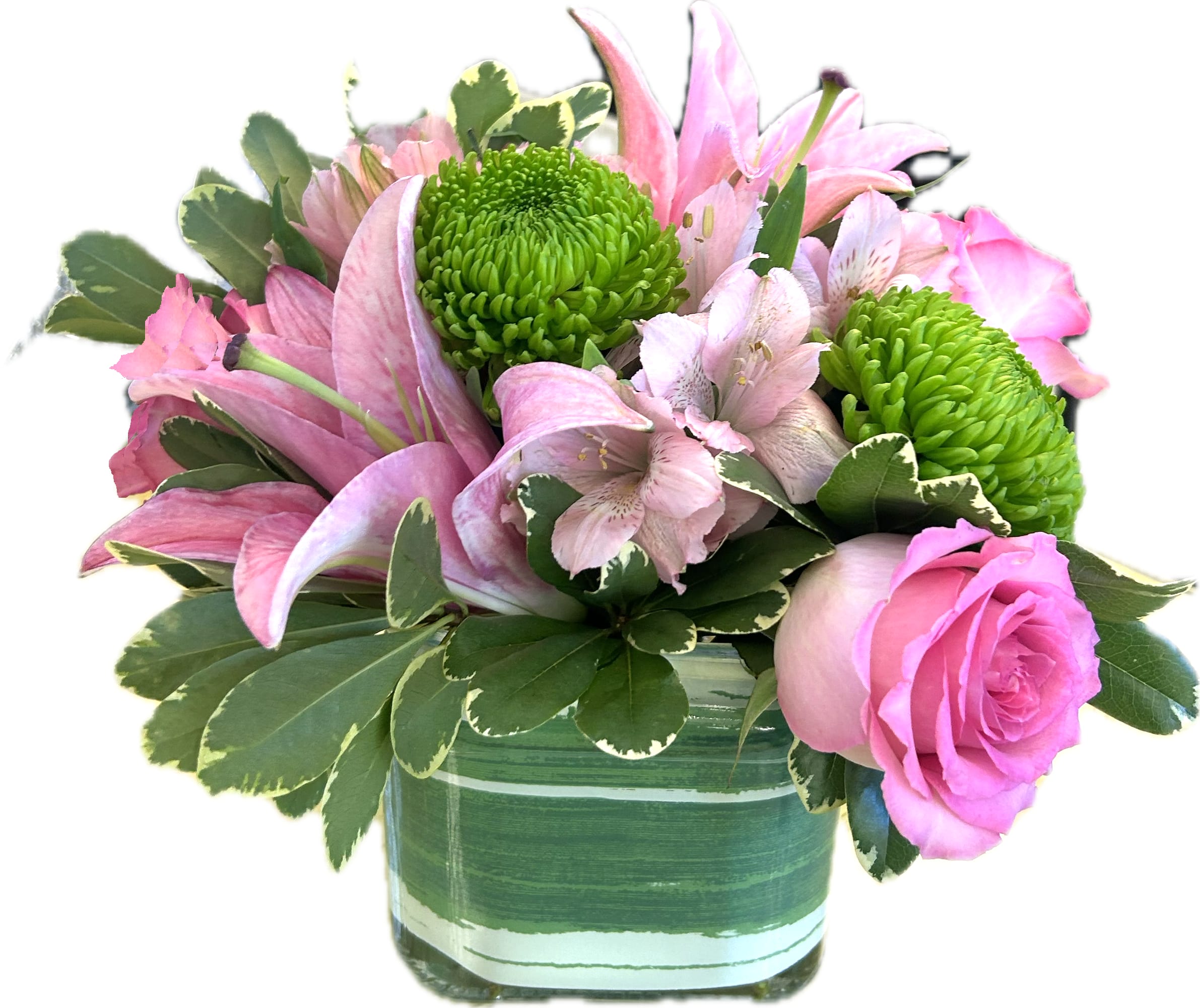 Compact arrangement of pink lilies and roses with green mums in a striped green glass vase