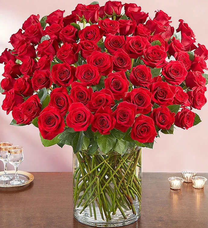 Large bouquet of red roses in a clear glass vase