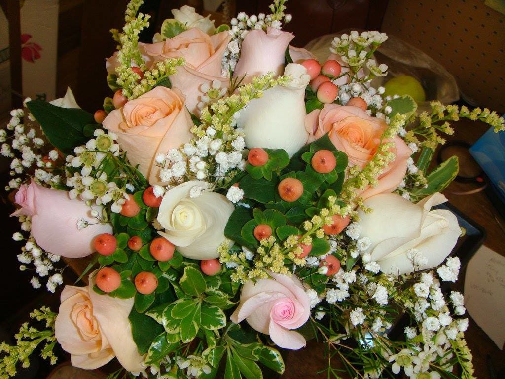 Bouquet of pale pink and white roses with small white filler flowers