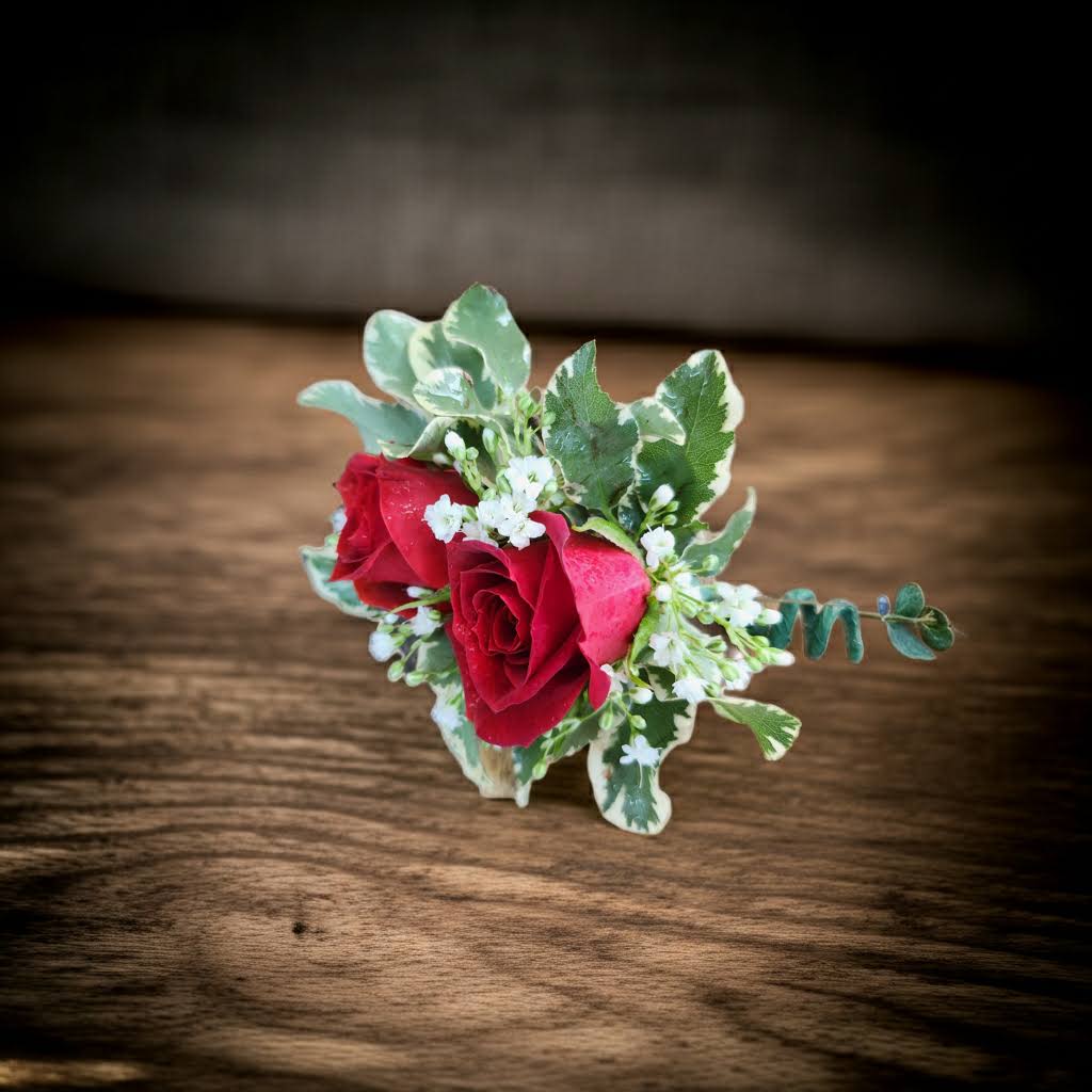 Small boutonniere with red roses and white filler flowers
