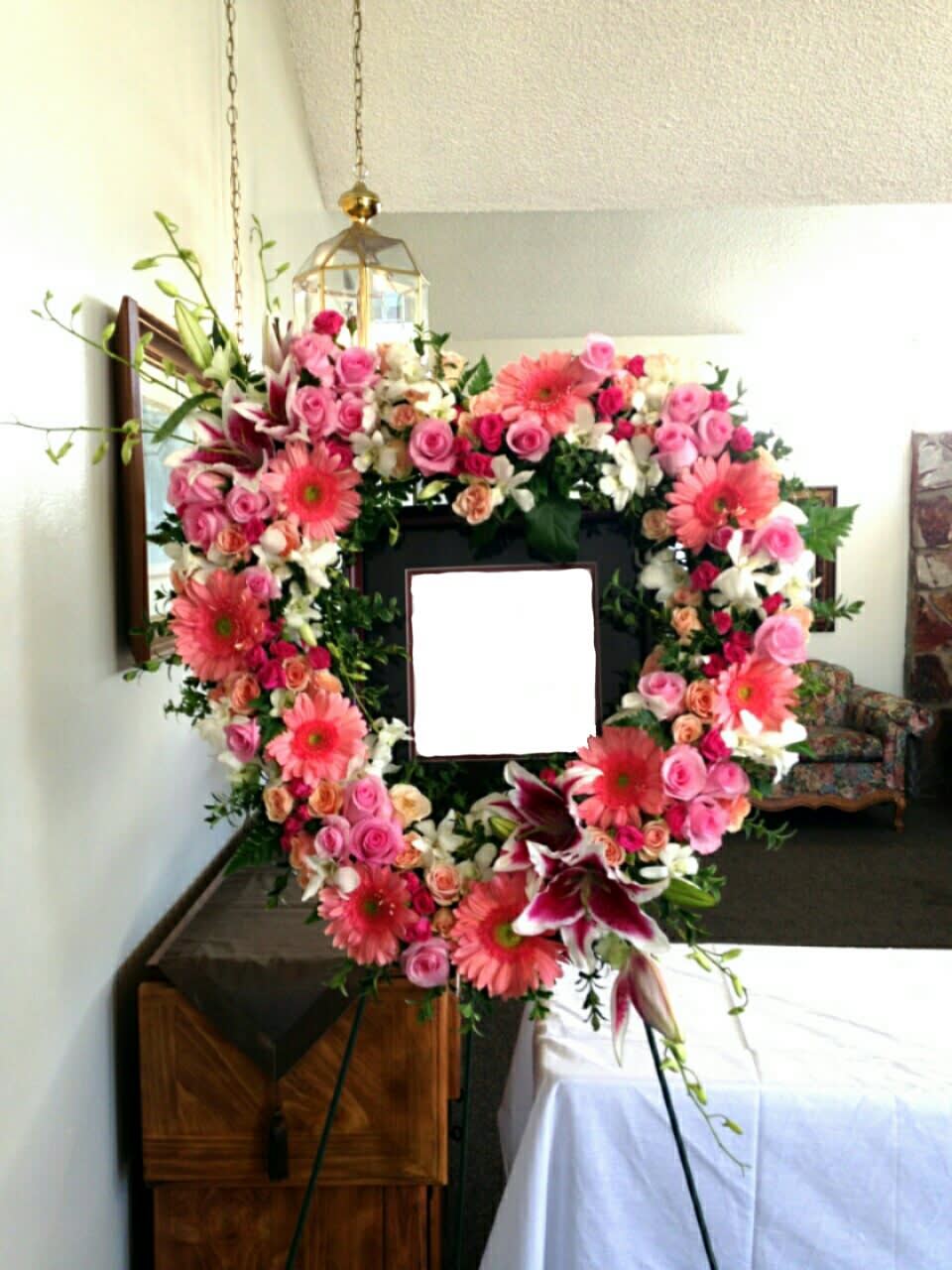 Heart-shaped floral wreath with pink roses and gerbera daisies