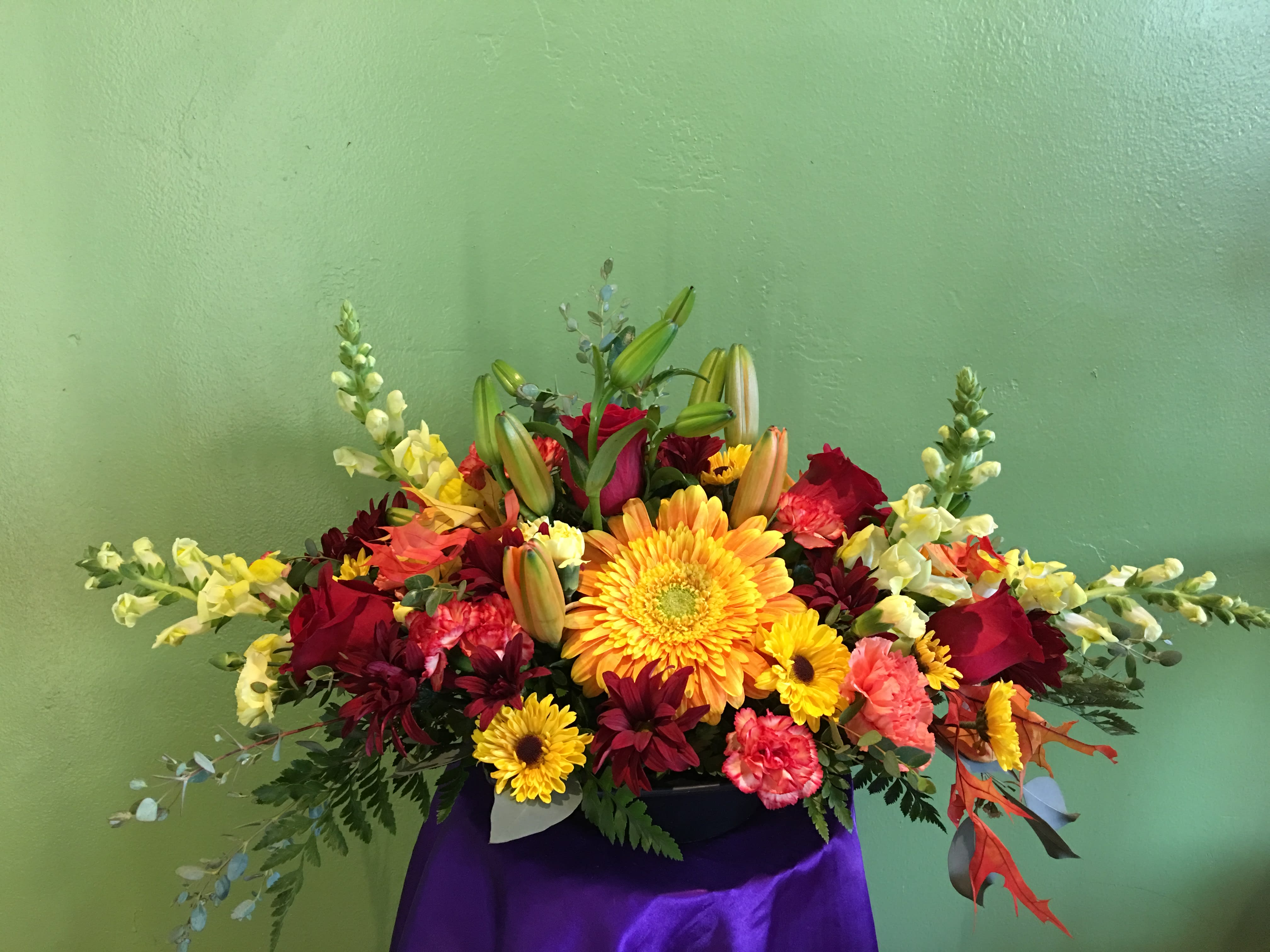 Colorful mixed flower arrangement with lilies, gerbera daisies, and roses