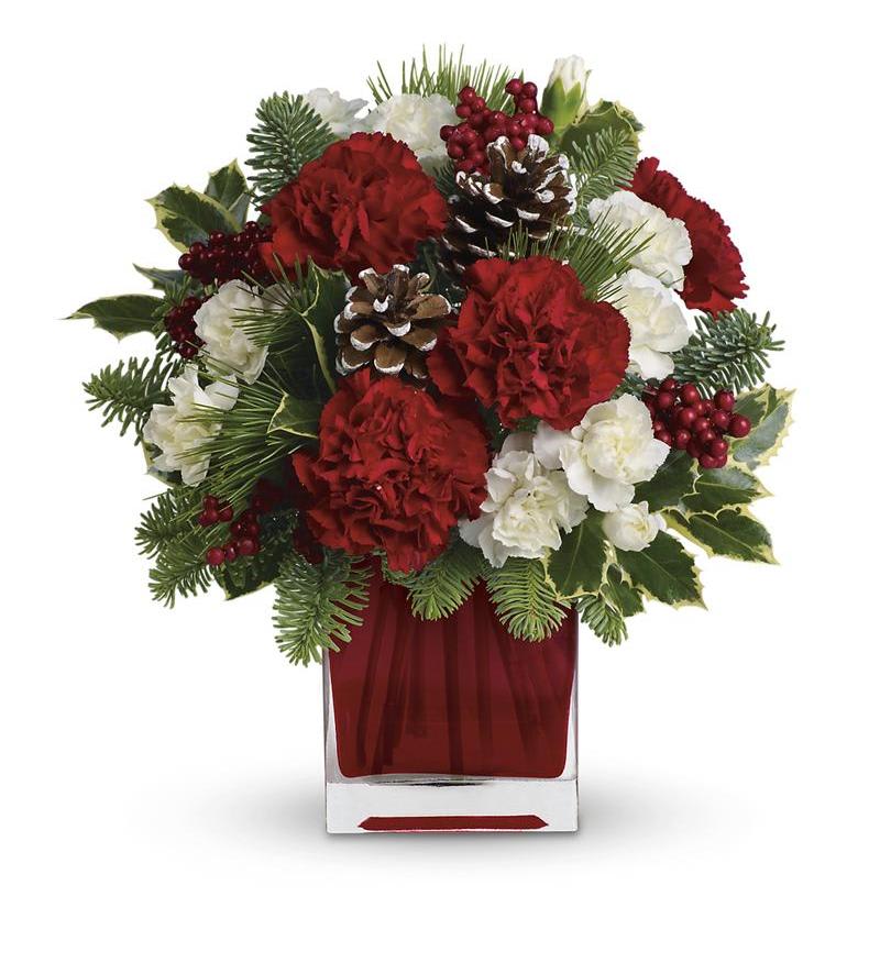 Red and white floral arrangement in a clear square vase