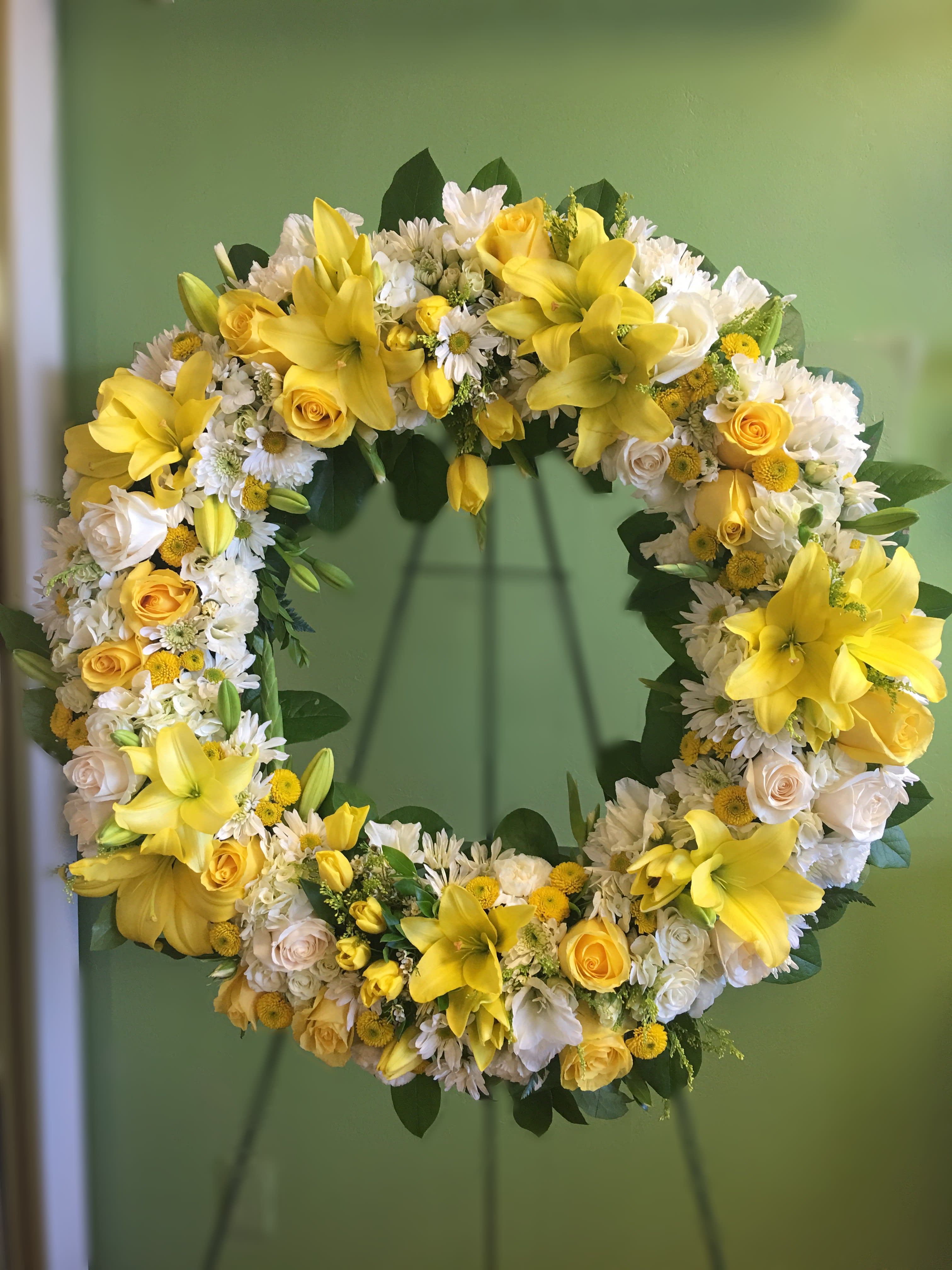 Yellow and white floral wreath with roses and lilies