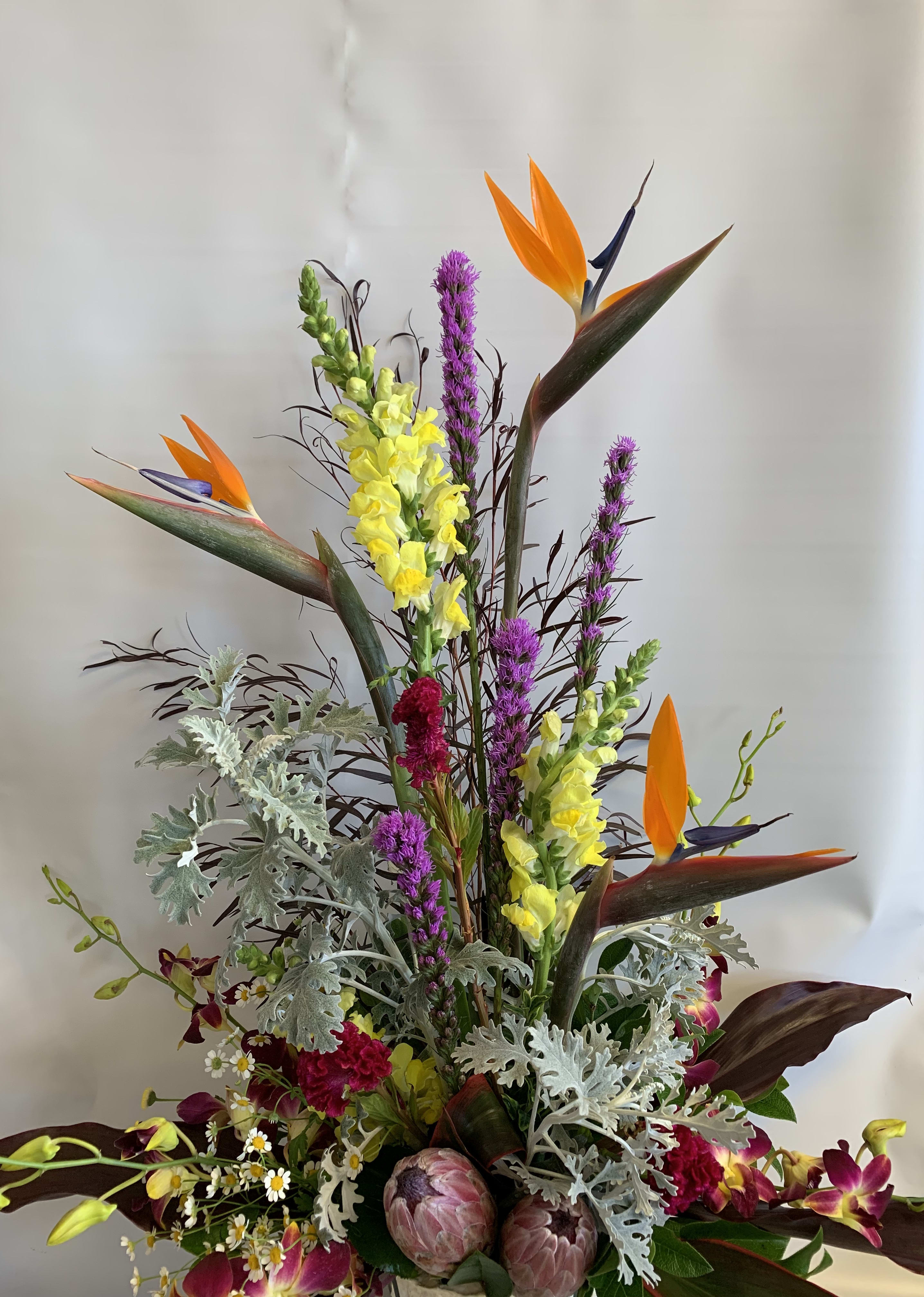 Tall tropical bouquet with orange bird-of-paradise and yellow snapdragons