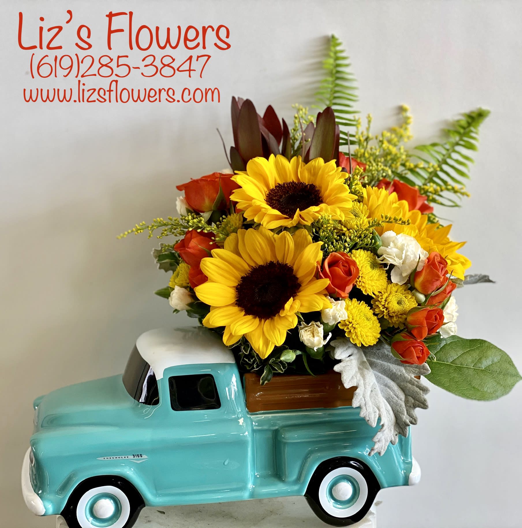 Sunflower and rose arrangement in a turquoise truck planter