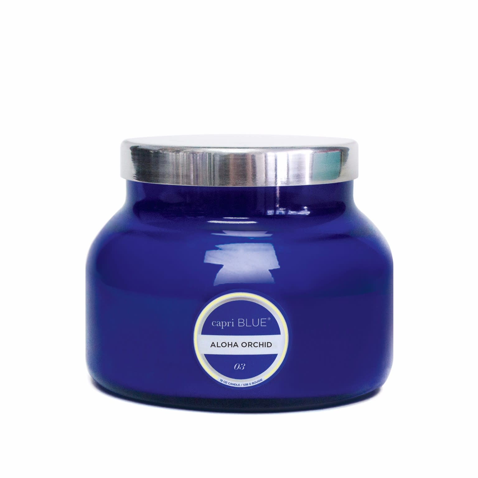Blue glass candle jar with a silver lid and label