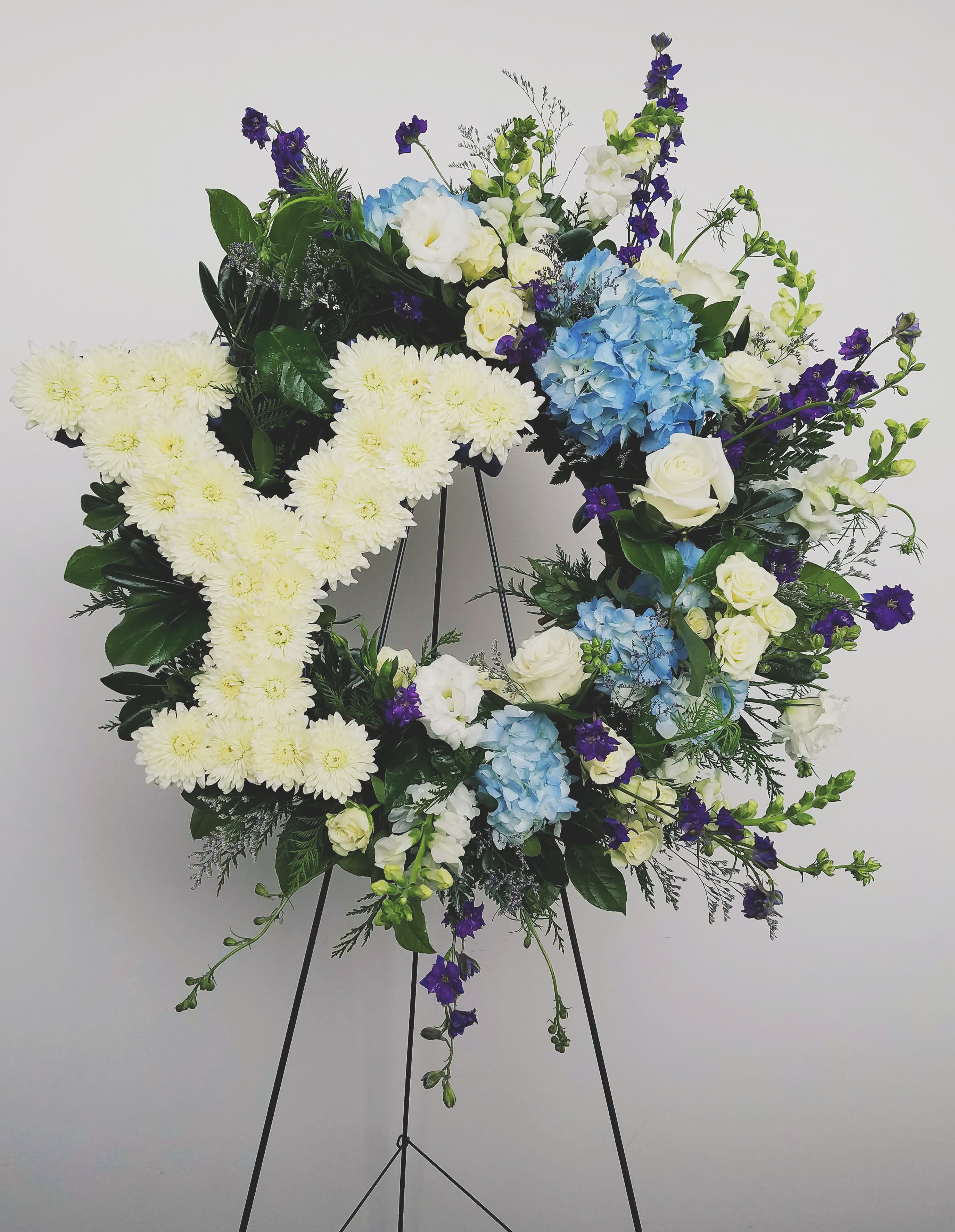 Cougar Tribute - 18 inch floral wreath lavishly filled with blue and white blooms and a Cut out Y adorned with flowers.  *Deluxe is shown in photo