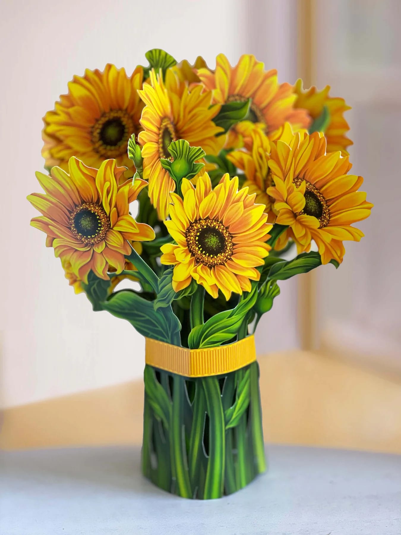 Bouquet of yellow-orange sunflowers in a green wrapped vase
