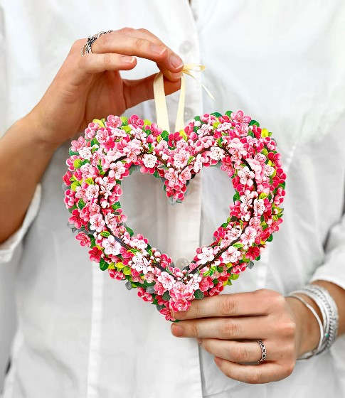 Heart-shaped floral ornament with pink and white blossoms
