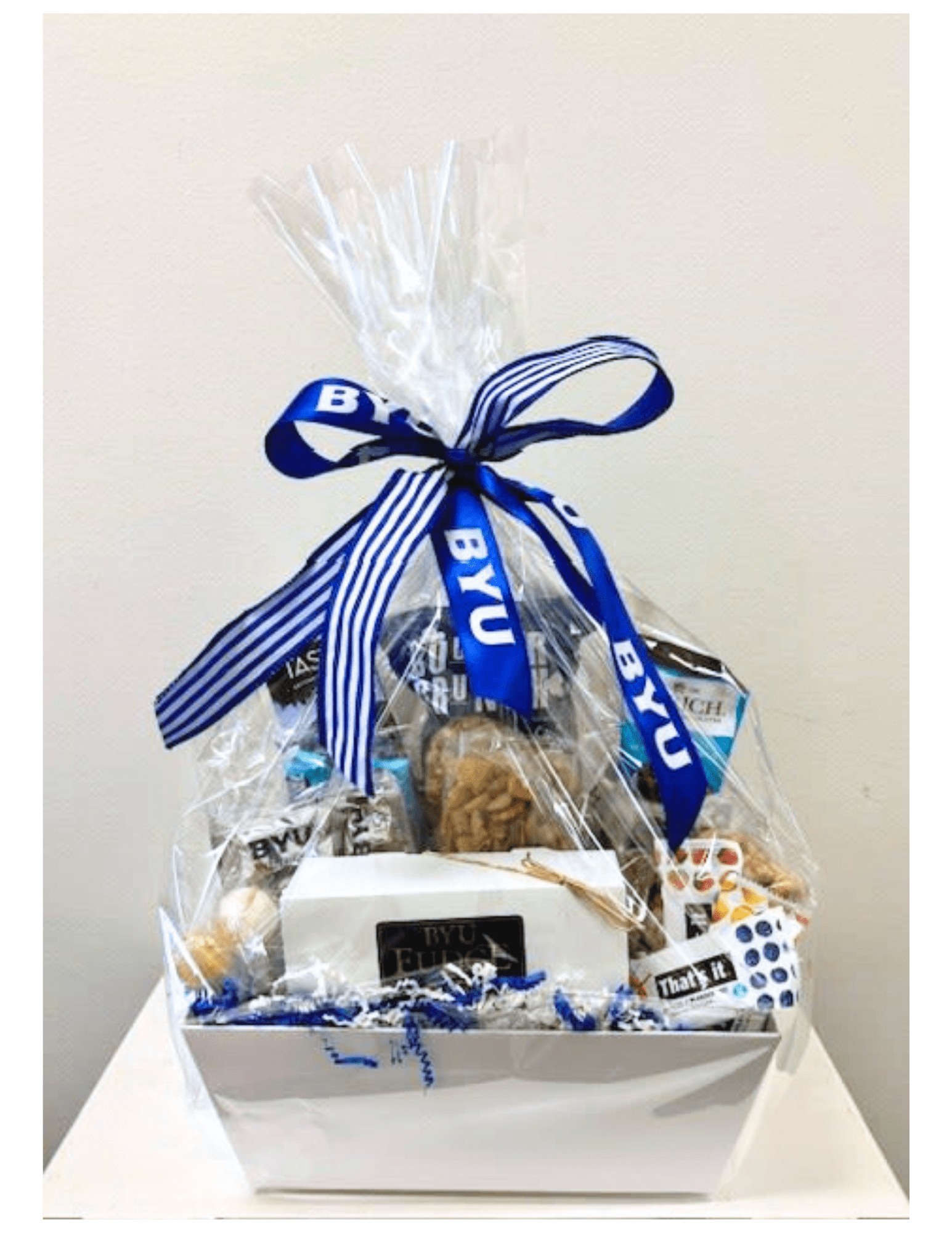 Gift Box - The perfect gift for the BYU fan or Distinguished guest. Filled with sweet and savory tastings, and BYU custom swag! Pictured at Premium. Maybe customizable due to diet restriction or other circumstances. In this case deluxe and premium must be chosen. If you would like a Gift basket filled to a different value higher than Premium, please call us directly to speak to a designer.