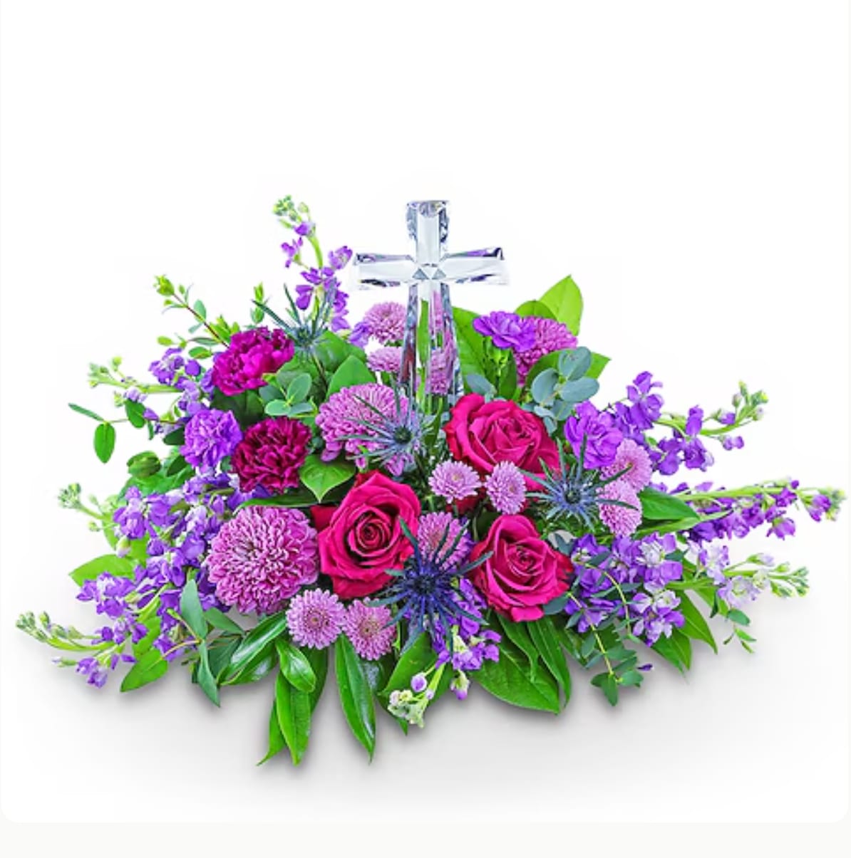 Purple and pink floral arrangement with a clear cross centerpiece