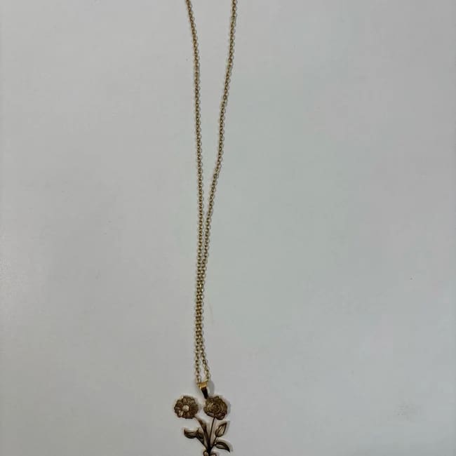 Gold necklace with a small floral pendant