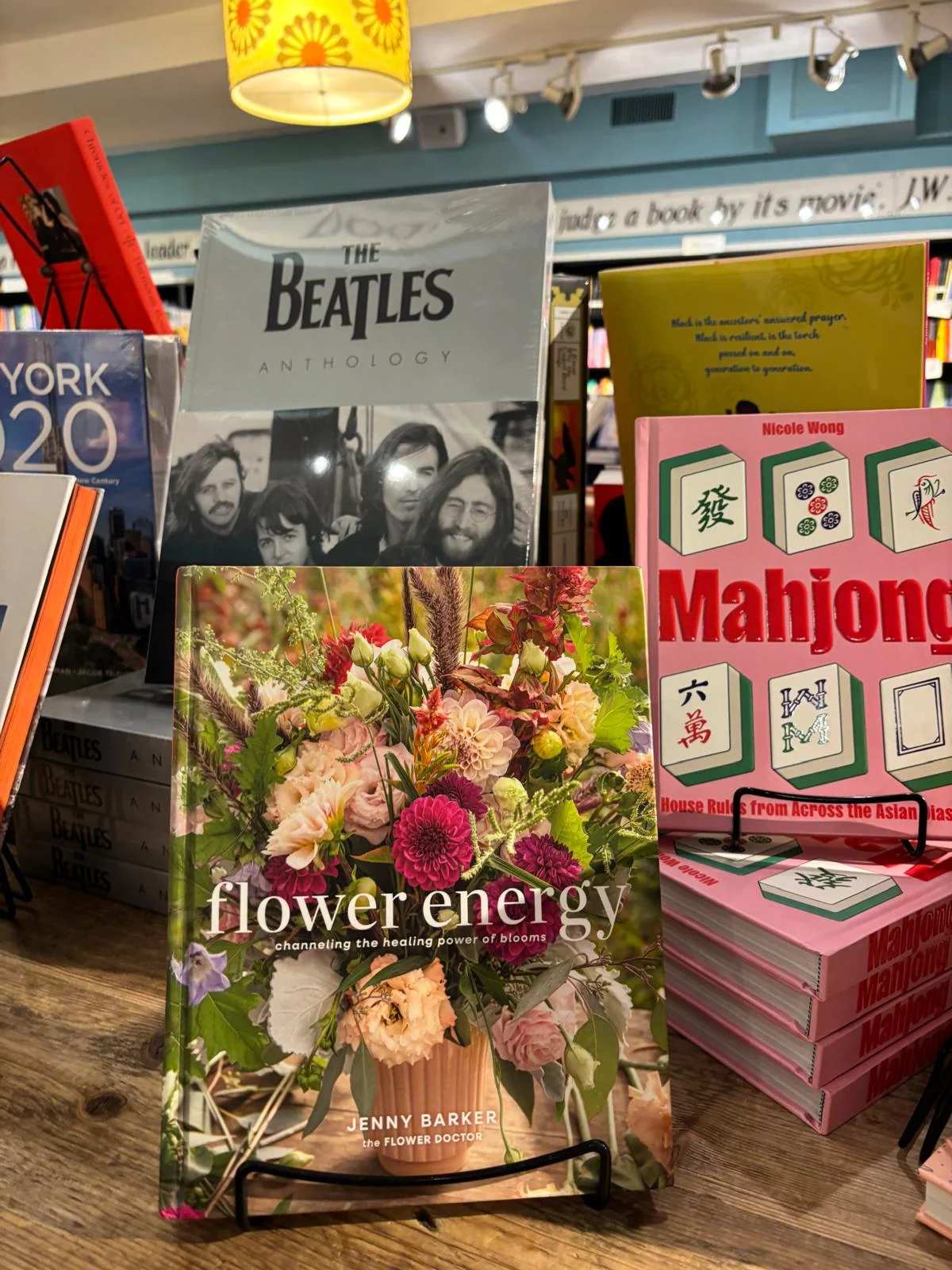 A flower-themed book displayed on a stand in a bookstore.