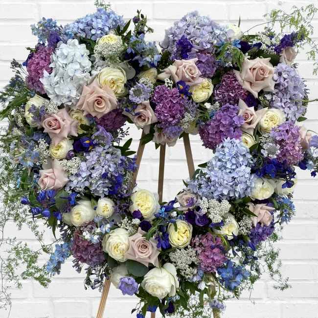 Heart-shaped floral wreath with pastel roses and hydrangeas