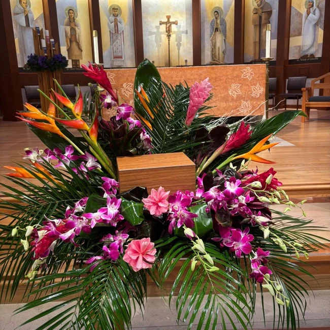 Tropical floral arrangement with orchids and bird-of-paradise flowers