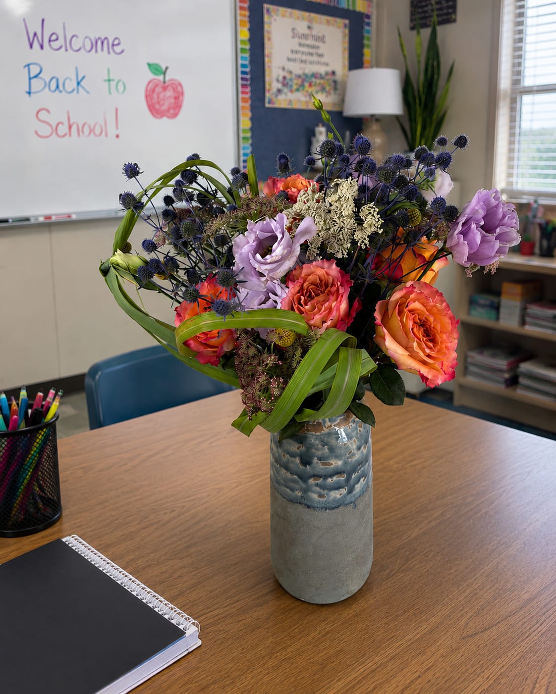 Bouquet of orange and lavender flowers in a blue ceramic vase
