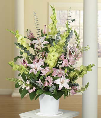 Tall pastel floral arrangement in a white pot