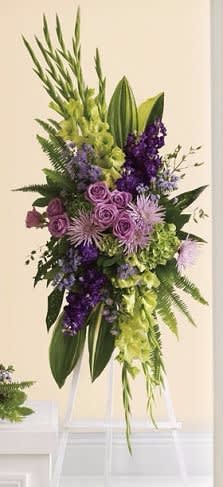 Tall purple and green floral spray on a white easel