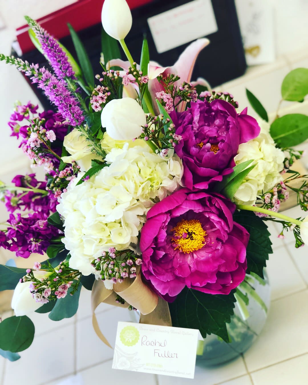 Bouquet of magenta peonies, white hydrangeas, and pink accent flowers