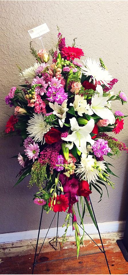 Standing floral spray with white lilies, pink and red blooms