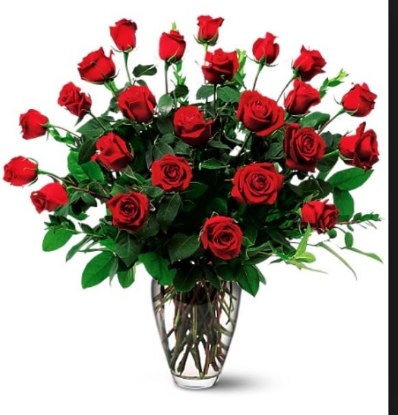 Red roses arranged in a clear glass vase