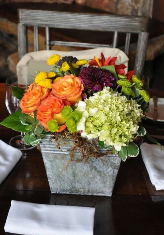 Mixed bouquet in a square metal container with orange roses and hydrangea