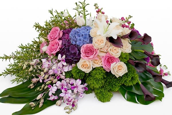 Mixed bouquet with pink roses, white lilies, and purple blooms