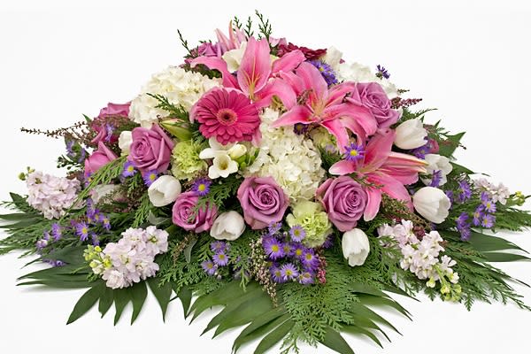 Pink and white floral spray with roses, lilies, and daisies