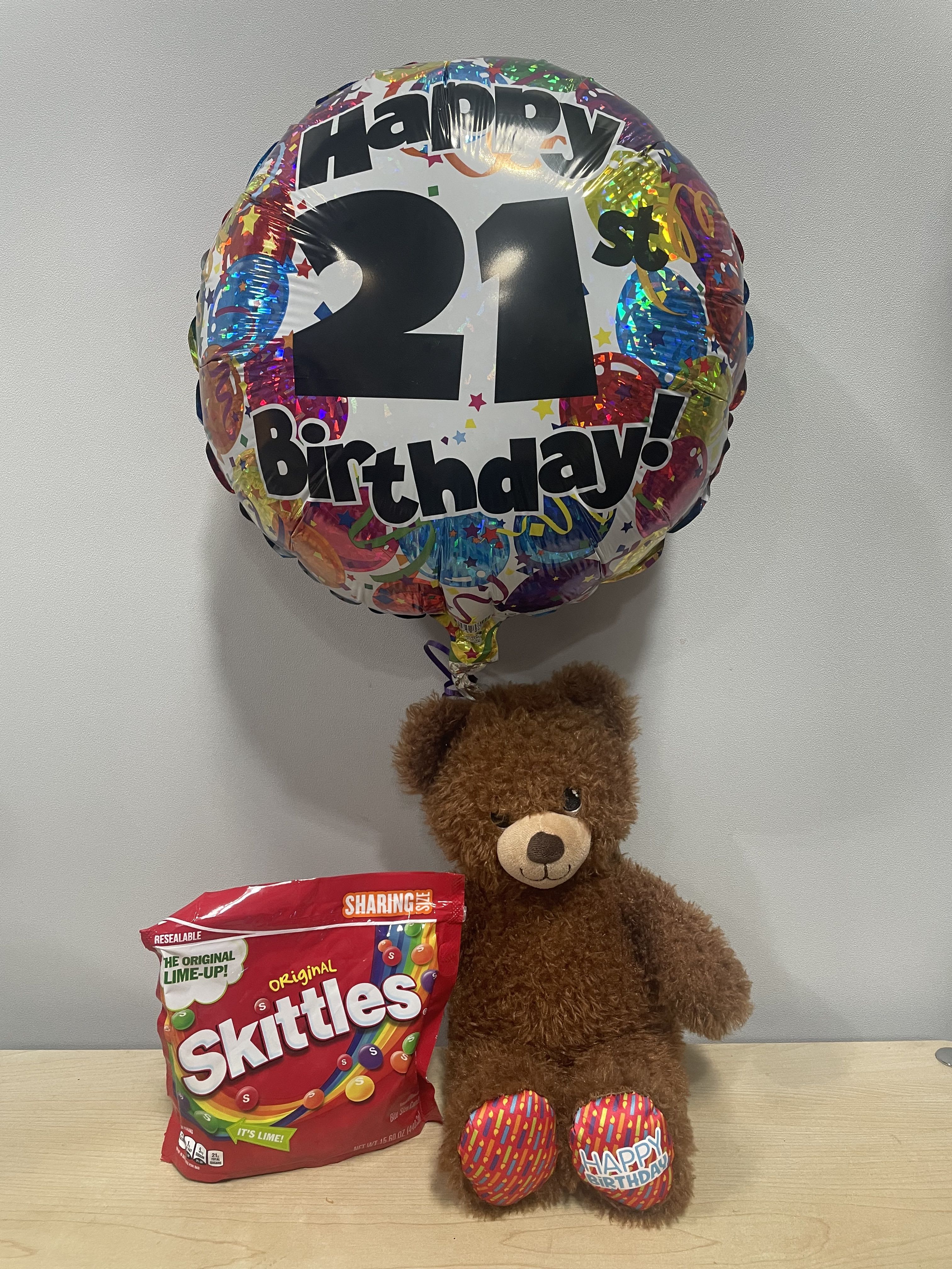 Birthday balloon with a teddy bear and a bag of Skittles candy