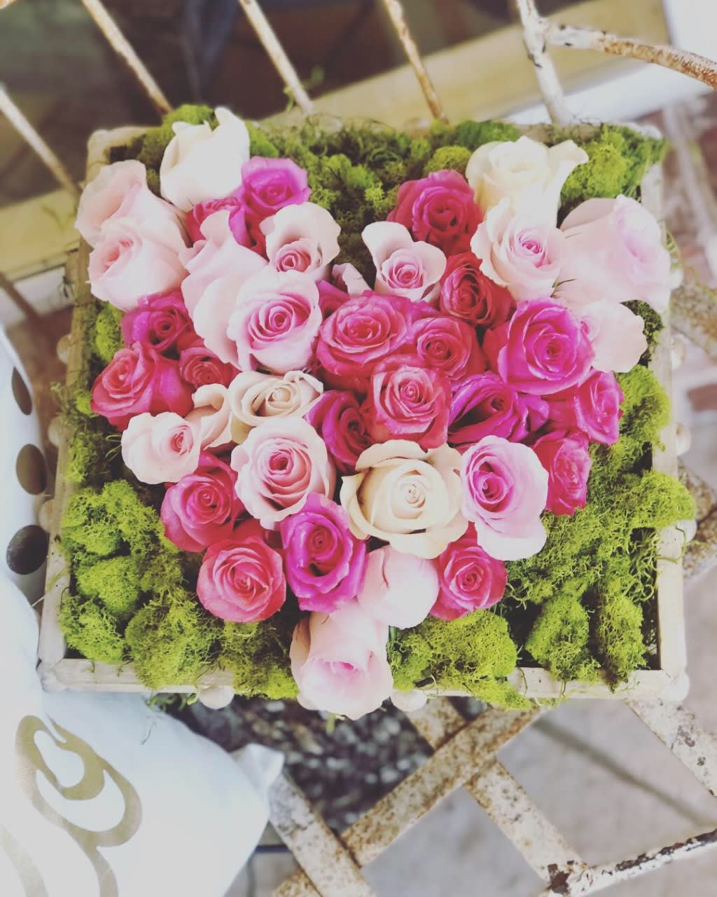 Heart-shaped box of pink and white roses with green moss trim