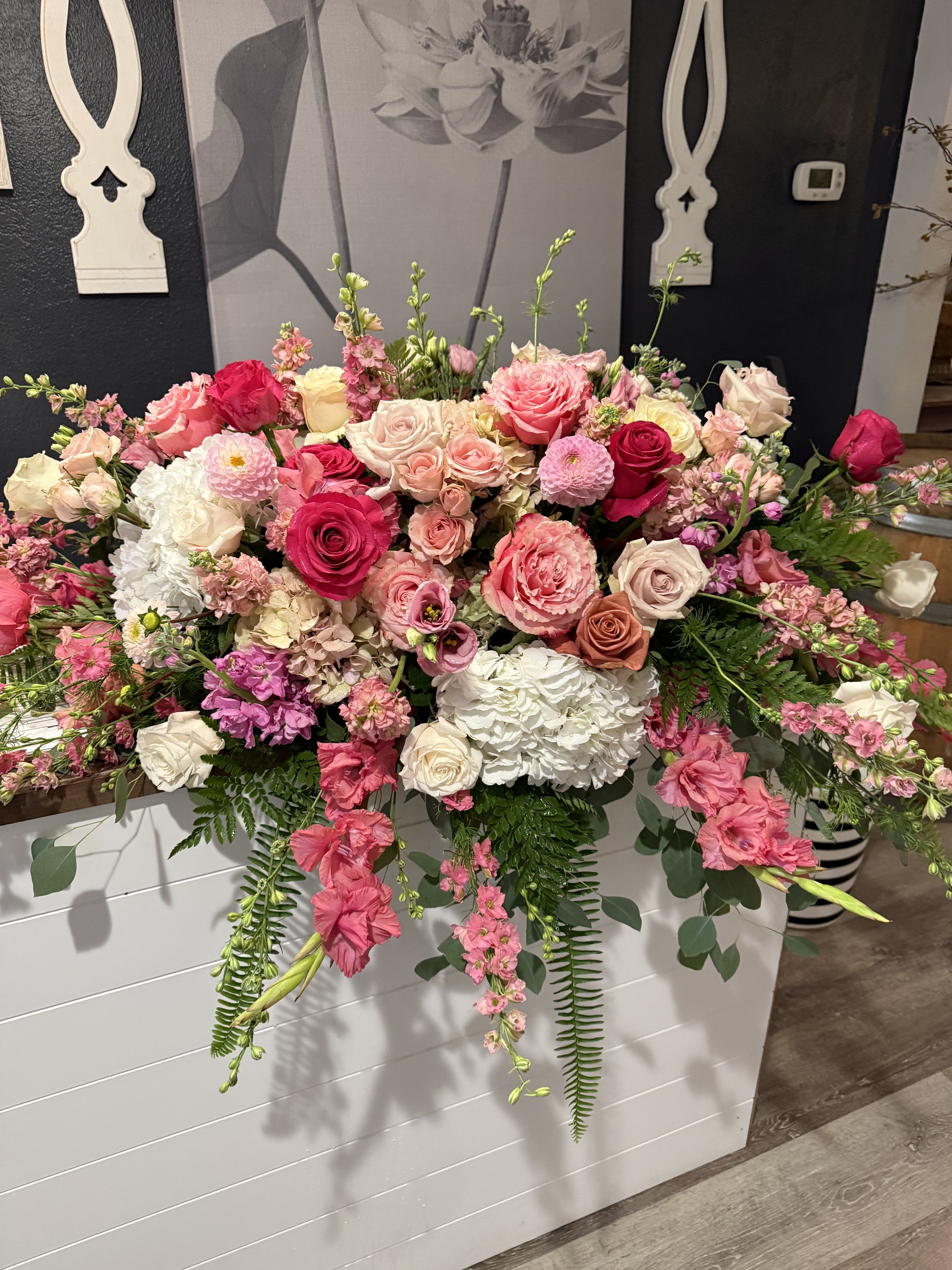 Large pink and white floral arrangement with roses and hydrangeas