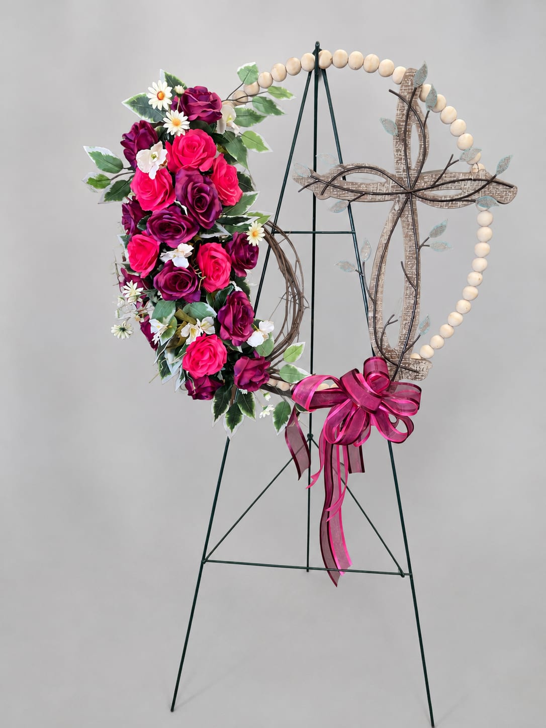 Floral heart wreath with pink and purple roses on a stand