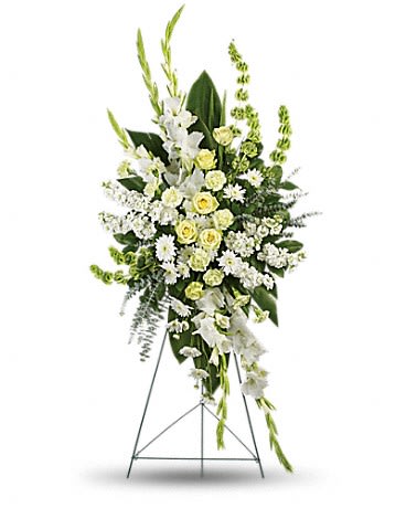 Standing floral spray of white and pale yellow flowers on an easel