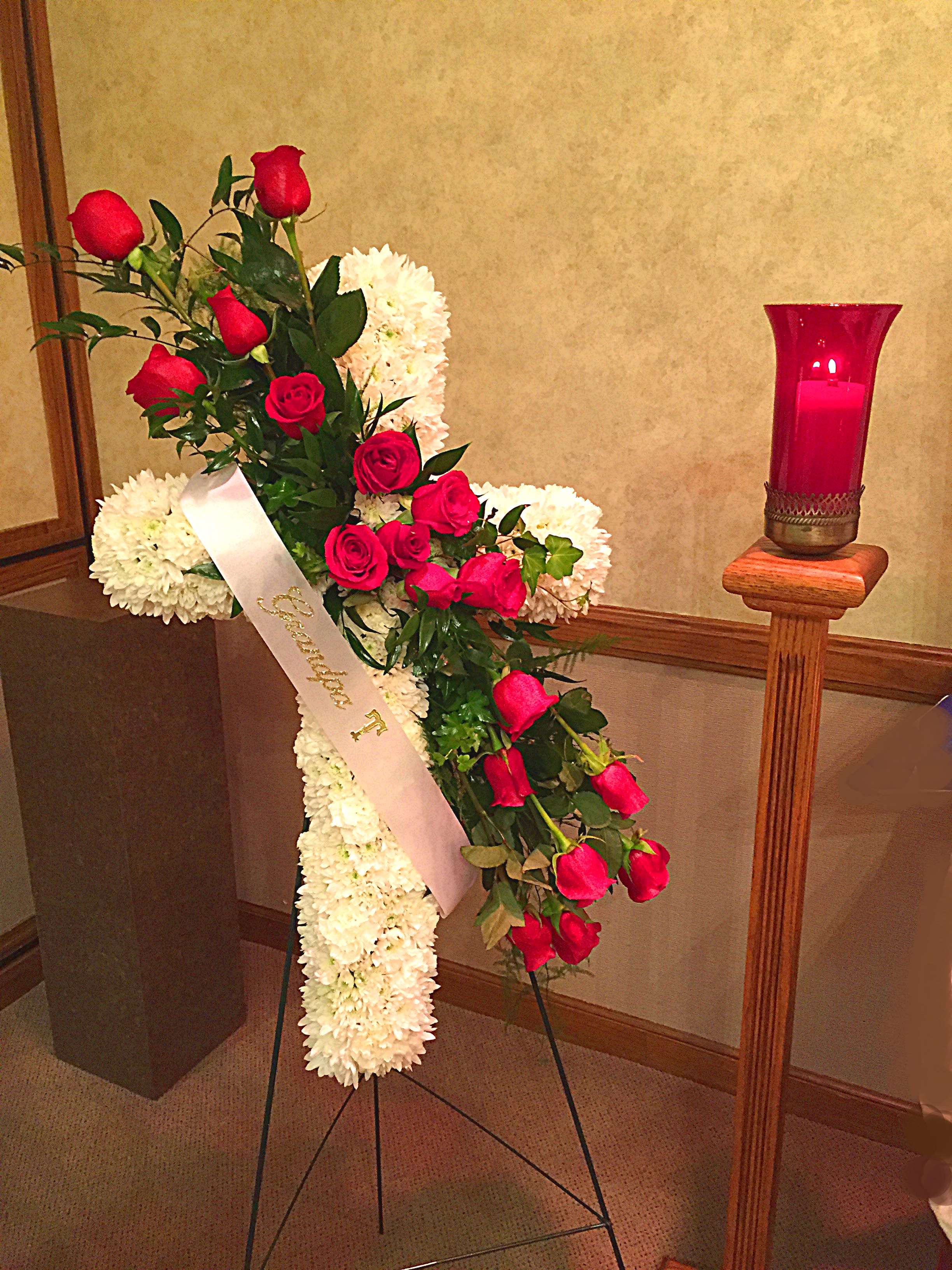 Standing floral spray with red roses and white chrysanthemums on an easel