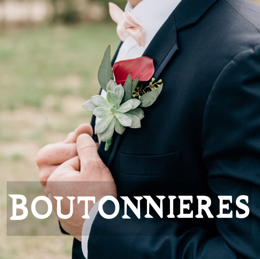 Boutonniere with a red calla lily and succulent on a suit lapel