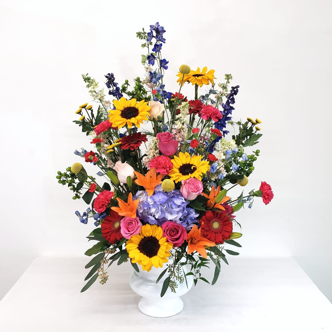 Over the Rainbow - Full of life and vibrant colors, this large urn arrangement is perfect for home or the service.