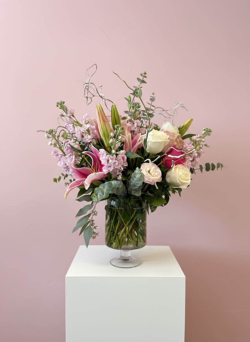 Pink and white floral arrangement in a glass vase