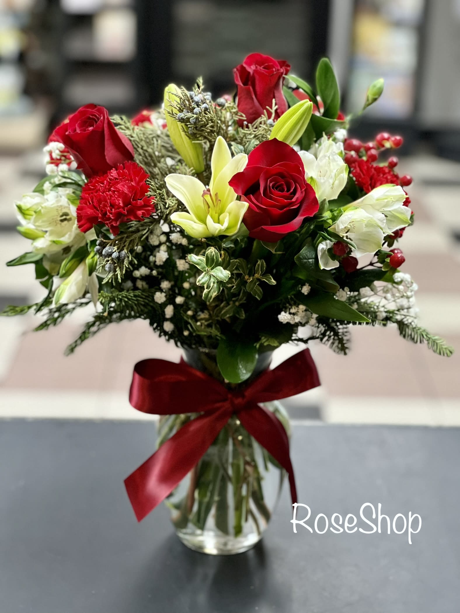 Warm Wishes - Fresh-picked red &amp; white blooms are hand-arranged in a glass vase tied with red ribbon, delivering your warmest wishes, while bringing you closer to the people you love.