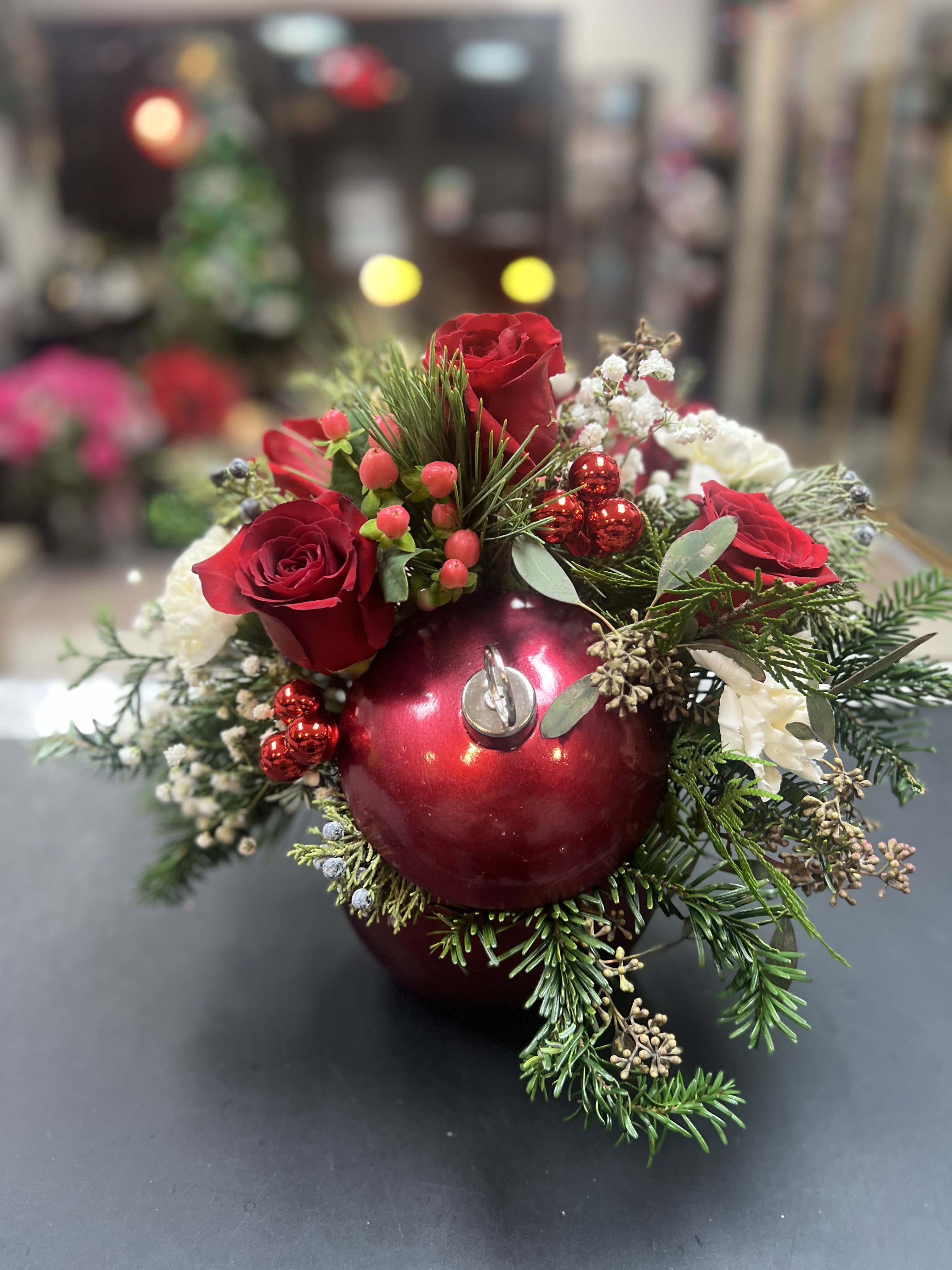 Ceramic Christmas Ornament  - An elegant combination of red flowers, nestled in a bed of Christmas greens, makes for an arrangement with a magical touch. 