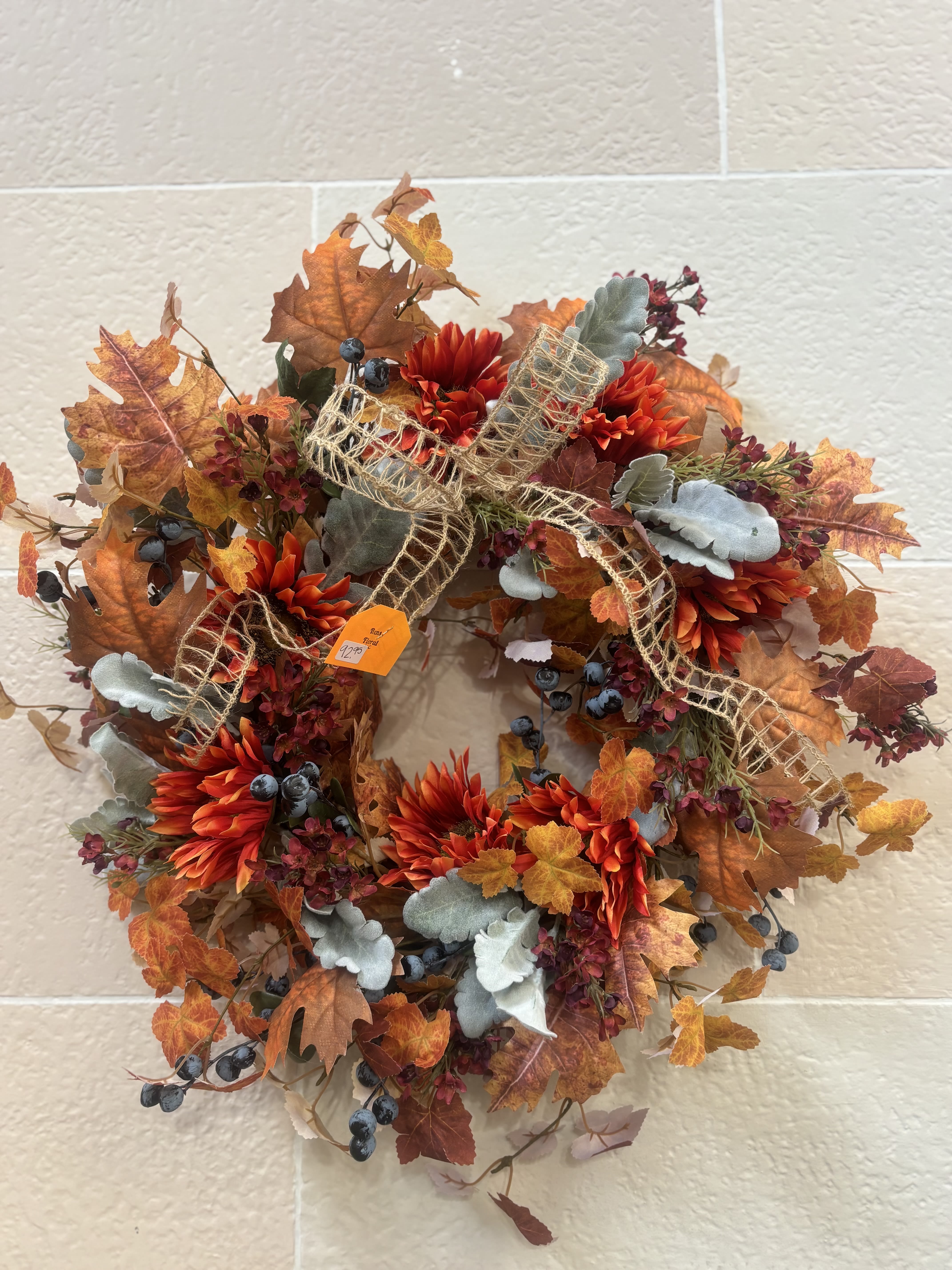 Berry and Greenery Fall Wreath - A sunflower and leaf wreath with berry and greenery accents. 