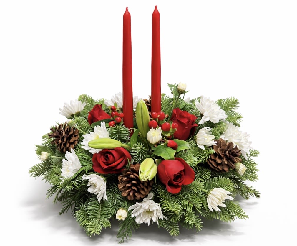 Holiday centerpiece with red candles, red roses, and white flowers