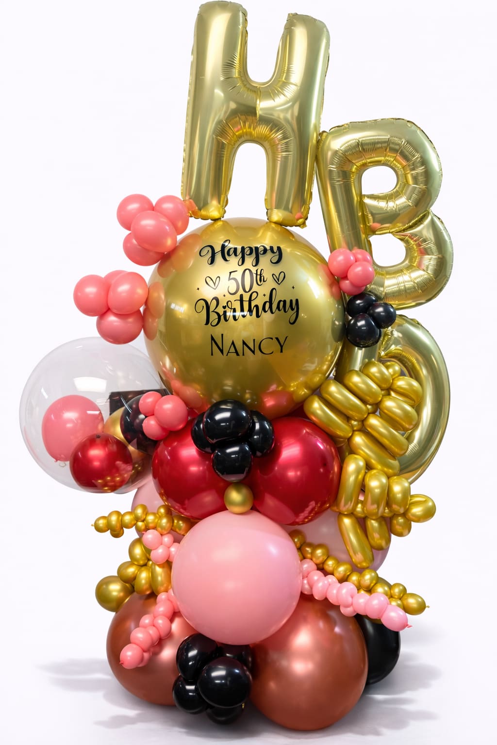 Gold 50th birthday balloon arrangement with pink and black accents