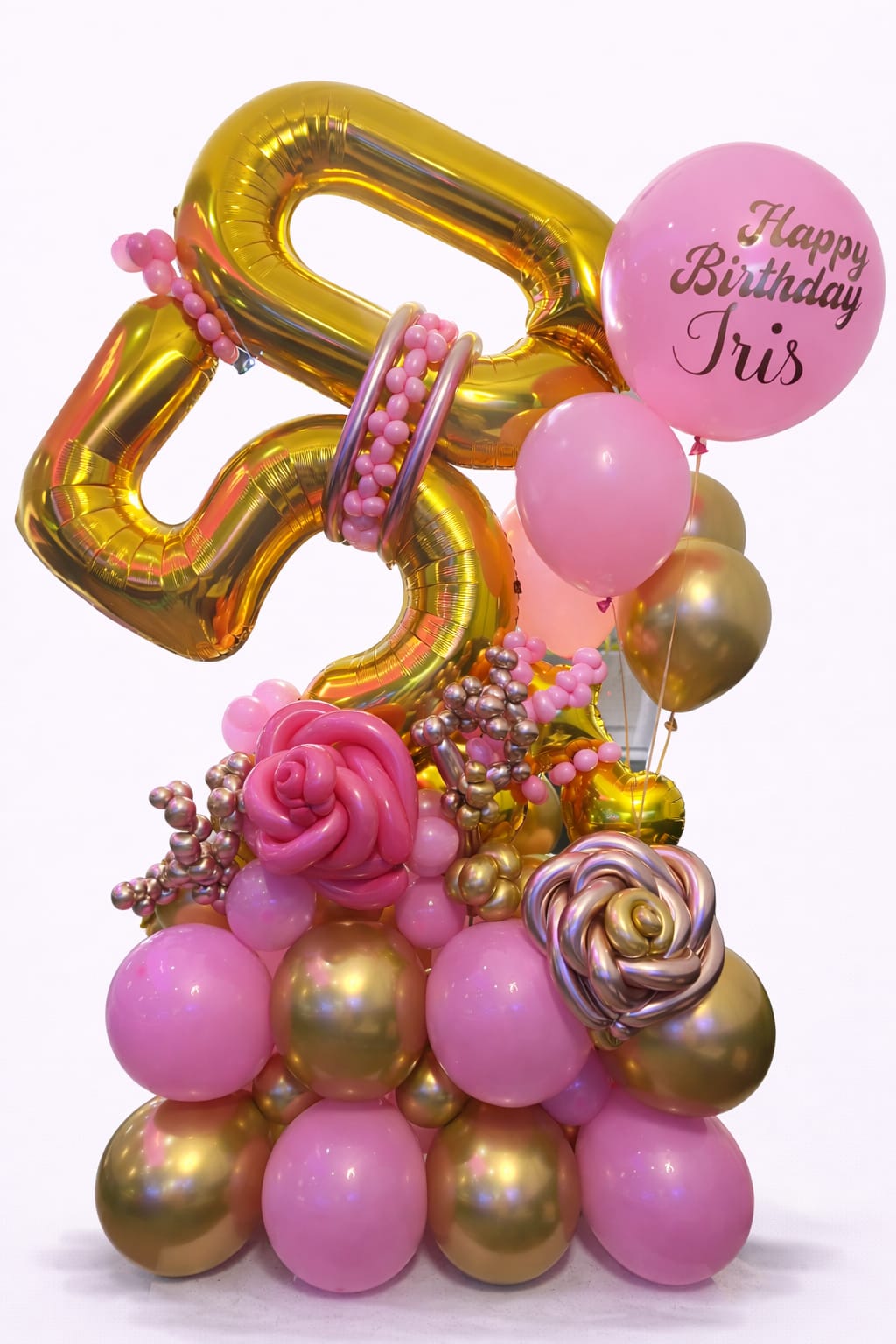 Pink and gold birthday balloon arrangement with a personalized balloon