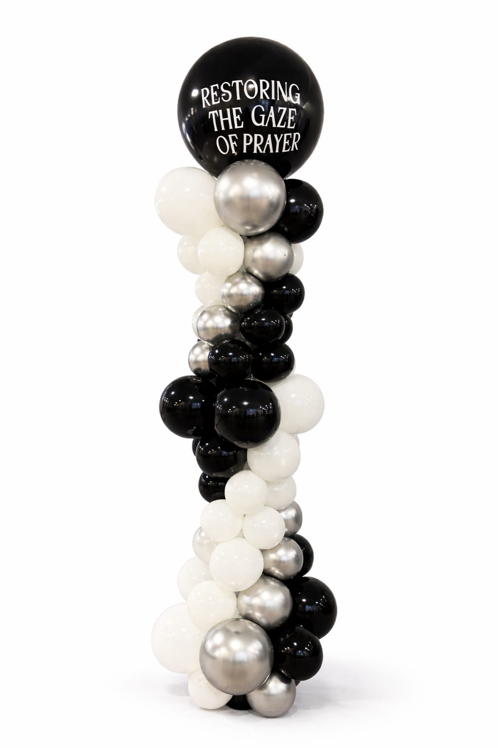 Black, white, and silver balloon column with a large printed top balloon