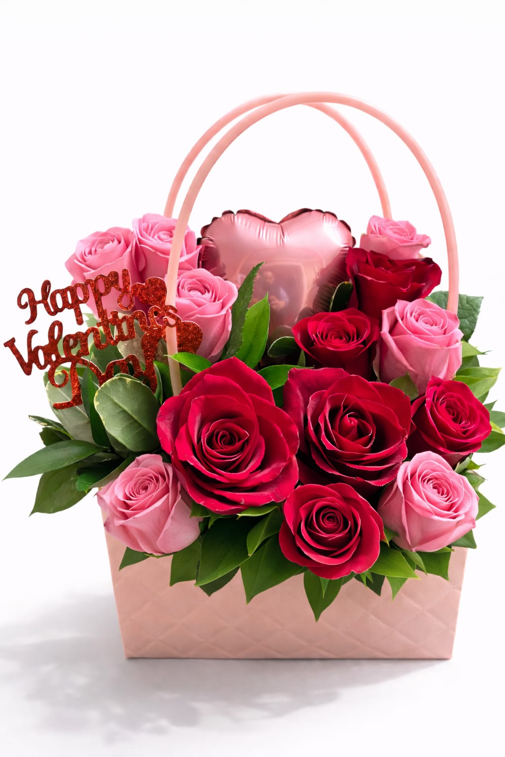 Pink and red roses in a gift basket with a heart balloon